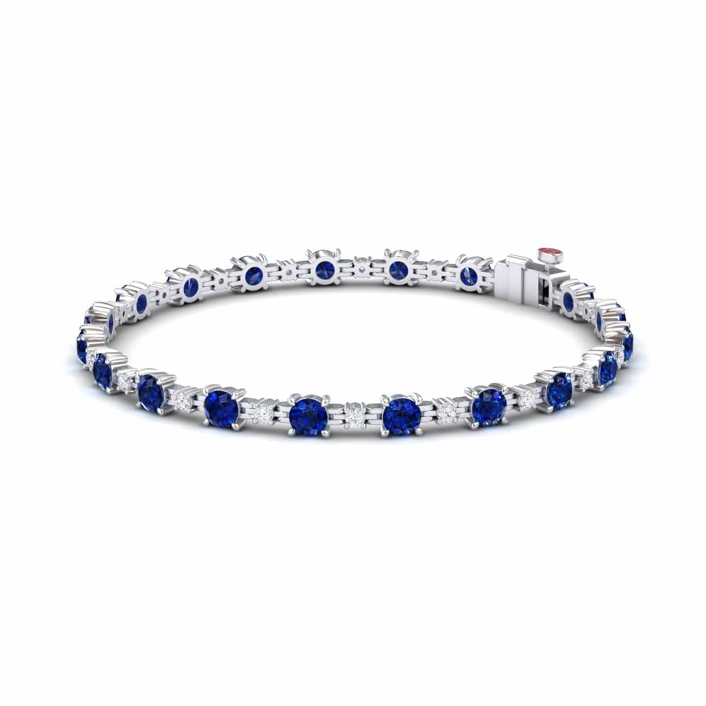 The Lab Grown Blue Sapphire & Diamond Halo Tennis Bracelet - Isabella features round blue sapphires and diamonds set in silver, with gemstones evenly spaced around the band, shown on a white background.