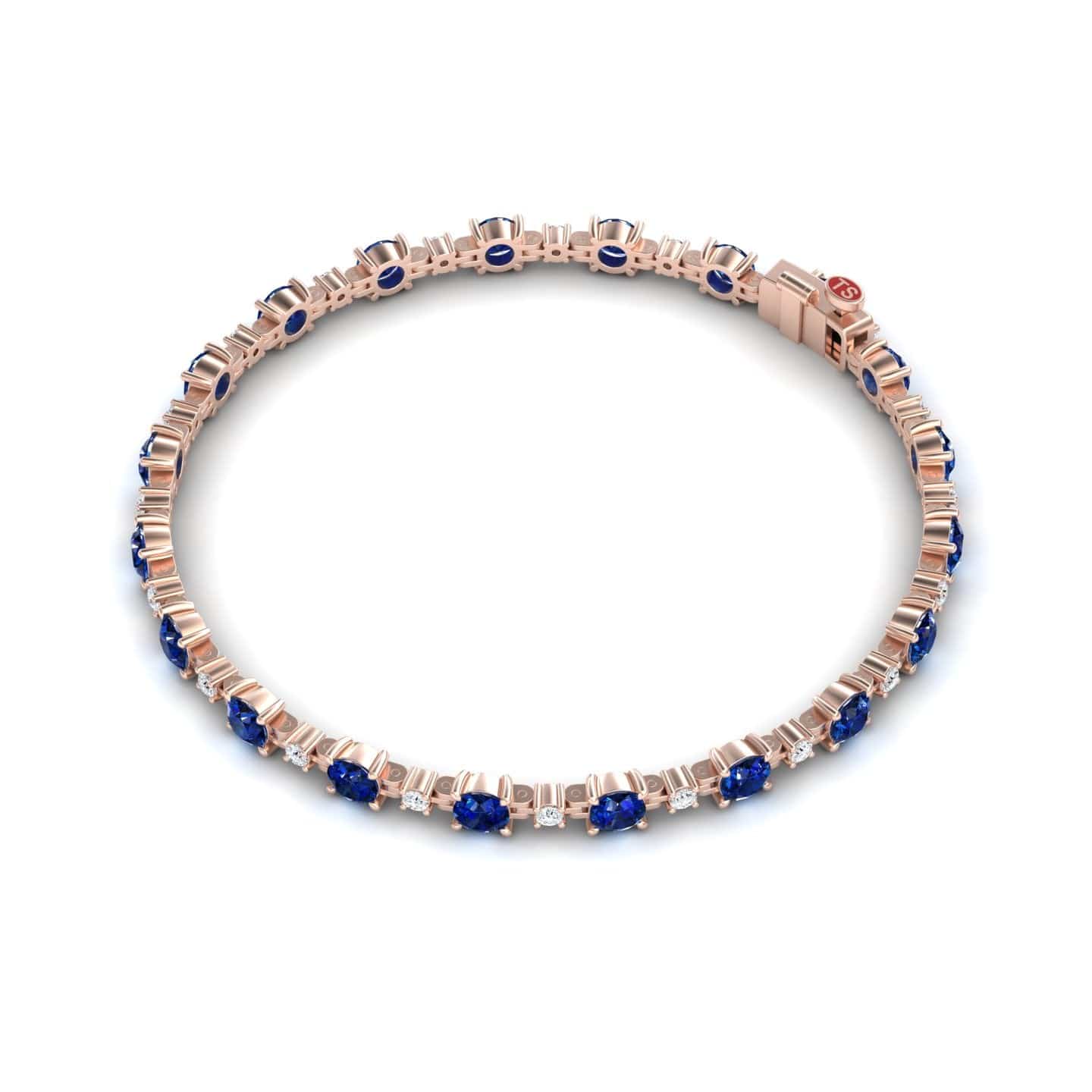 The Blue Sapphire & Diamond Tennis Bracelet - Natalia features alternating round blue sapphires and small white diamonds set symmetrically in a rose gold band.