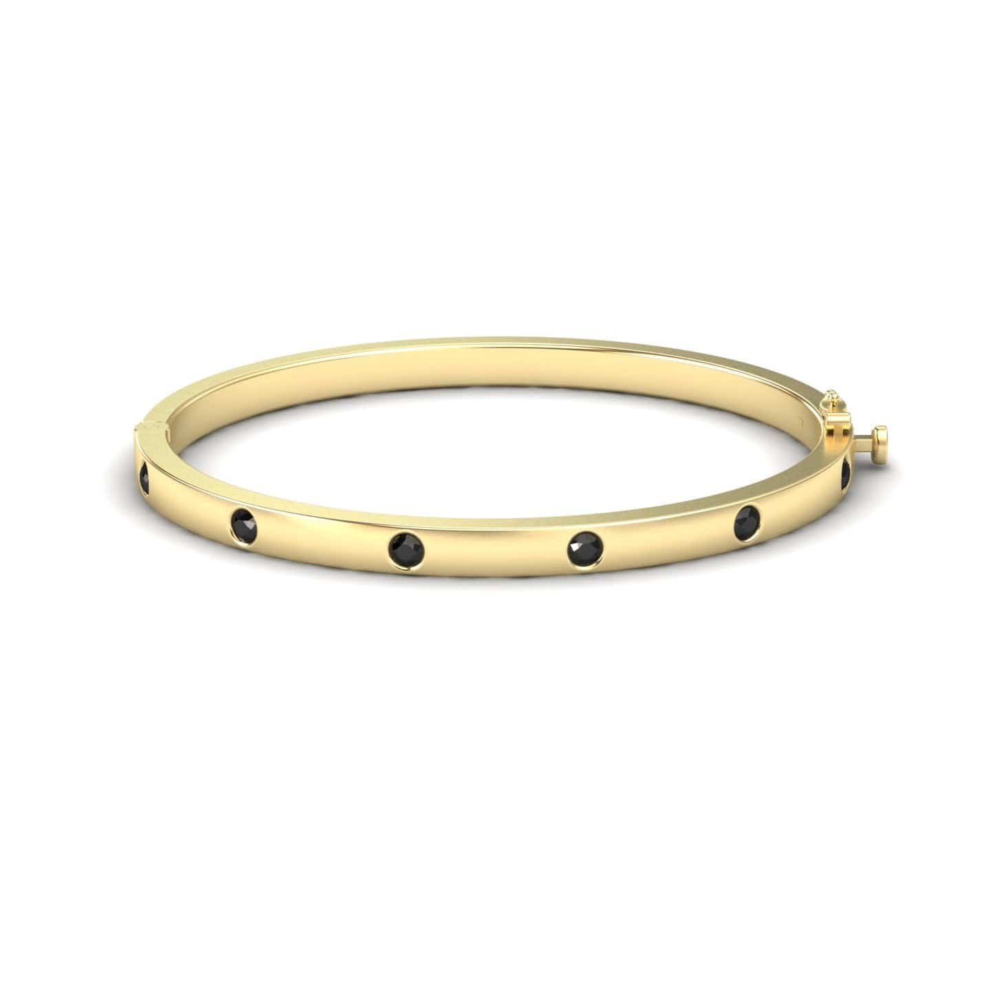 The Black Diamond Bezel-Set Bracelet - Flavia features evenly spaced black gemstones set in gold, displayed against a plain white background.