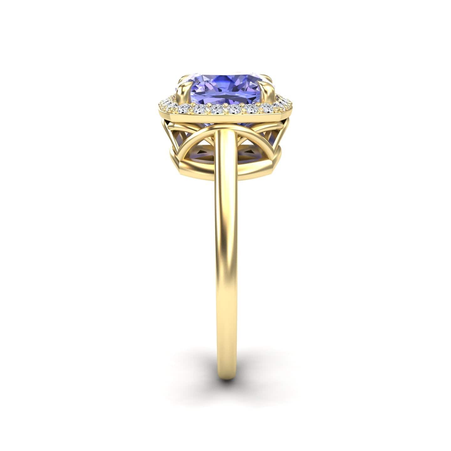 The Tanzanite & Diamond Halo Ring - Ziva features a slim gold band with a cushion-cut tanzanite center stone, encircled by sparkling white diamonds in a halo setting, shown from the side on a white background.