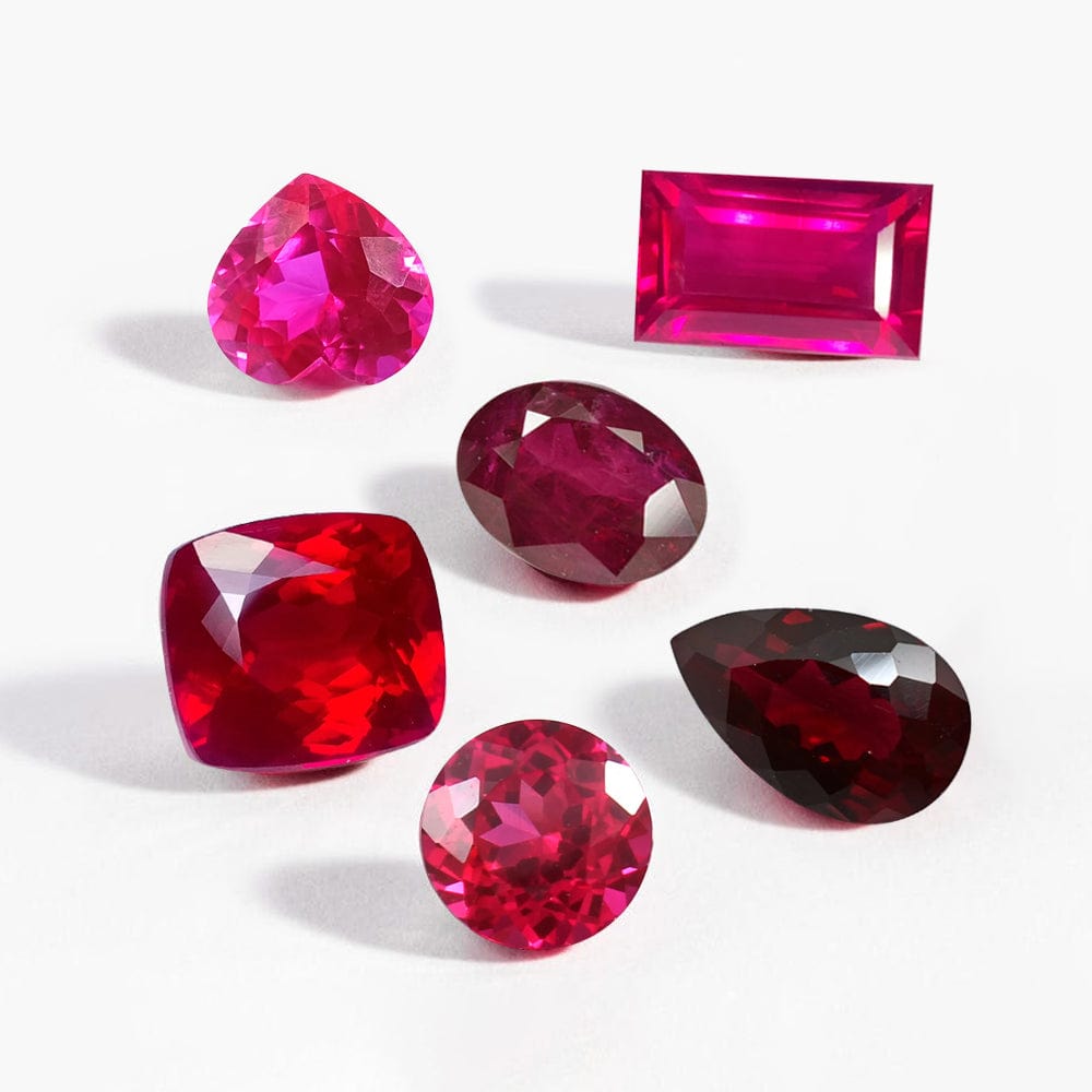 Collection of ruby gemstones on a white background