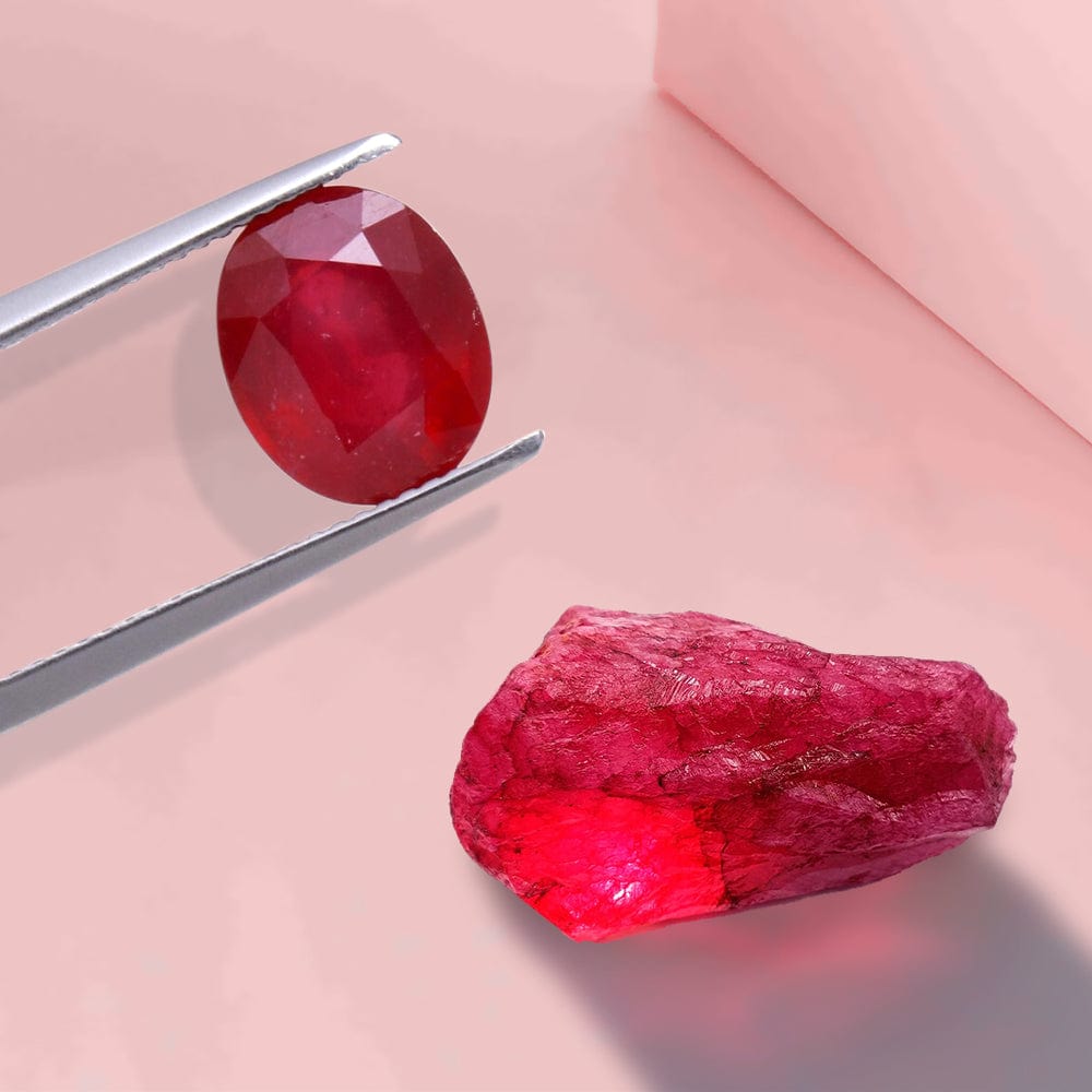 Faceted red gemstone and rough red gemstone on a pink background