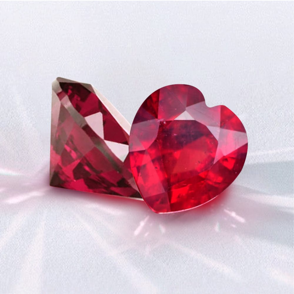 Two red heart-shaped crystals on a white background