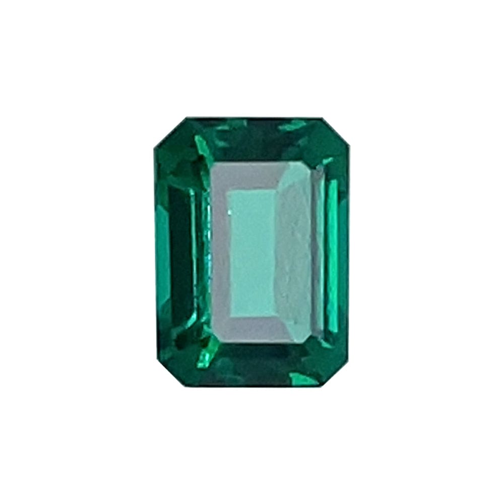 A 7x5 Exceptional Emerald Color Lab Created Emerald, emerald-cut with beveled corners and vibrant color, displayed against a white background.