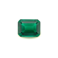 The 9x7 Exceptional Emerald Color Lab Created Emerald is a rectangular, emerald-cut green gemstone with beveled edges, shown against a plain white background.