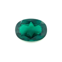 The 14.0x10.0 Exceptional Oval Color Lab Created Emerald features vivid, deep green color with faceted brilliance, sparkling against a plain white background.