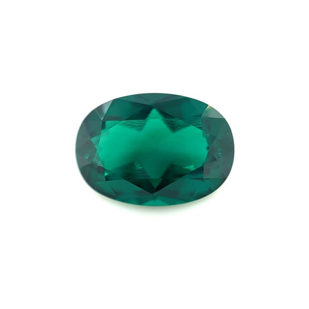 The 14.0x10.0 Exceptional Oval Color Lab Created Emerald features vivid, deep green color with faceted brilliance, sparkling against a plain white background.