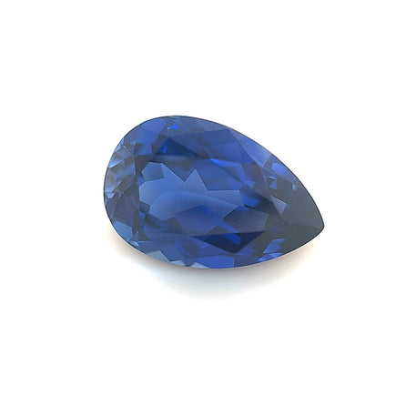 An exceptional 12.0x8.0 lab created blue sapphire, pear-shaped and faceted, featuring deep vibrant color and a reflective surface, displayed against a plain white background.