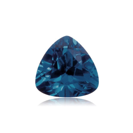 An 8mm Exceptional Pear Trillion Created Blue Sapphire is displayed against a white background, highlighting its faceted cut, deep blue color, and brilliant reflective surface.