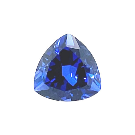 A brilliant blue 9mm Exceptional Pear Trillion Created Blue Sapphire with a sparkling surface and bold triangular shape, showcased against a plain white background.