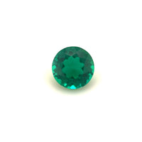 The 5.5mm Exceptional Round Zambian Color Lab Created Emerald is shown against a plain white background, highlighting its vibrant green hue and sparkling facets.