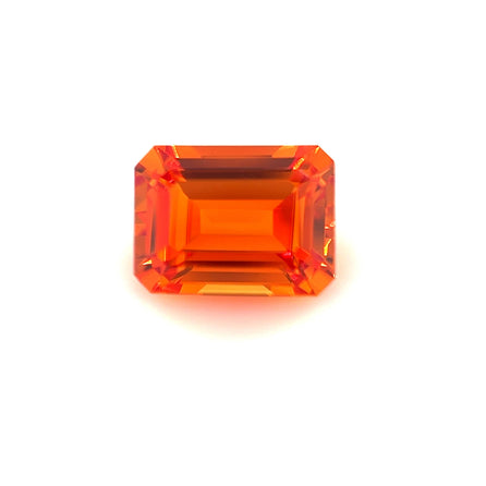 An 8.0x6.0 exceptional emerald-cut lab created orange sapphire is shown against a plain white background.