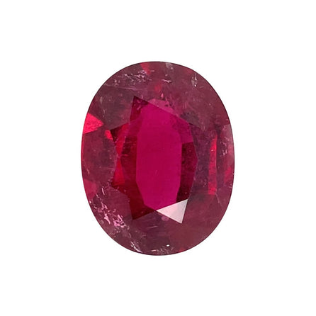 A 9.54 carat, 16.4x13.0mm oval premium Rubellite Tourmaline with a deep red hue and reflective surface is displayed on a plain white background.