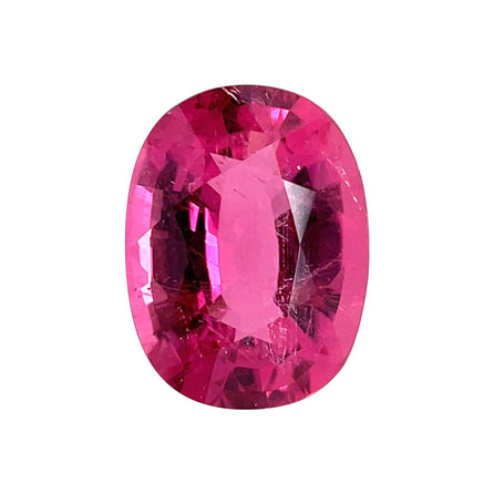 An 8.91 carats oval premium rubellite tourmaline (16.2x12.1 mm), untreated and vibrant, sparkles in multiple pink shades on a plain white background, highlighting its precise faceting and natural beauty.
