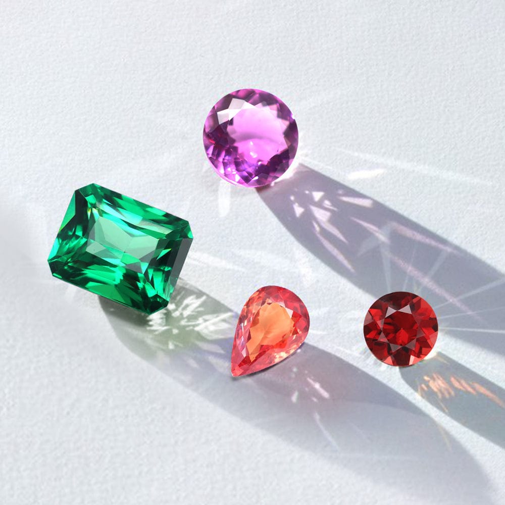 Four colorful garnet gemstones on a white background
