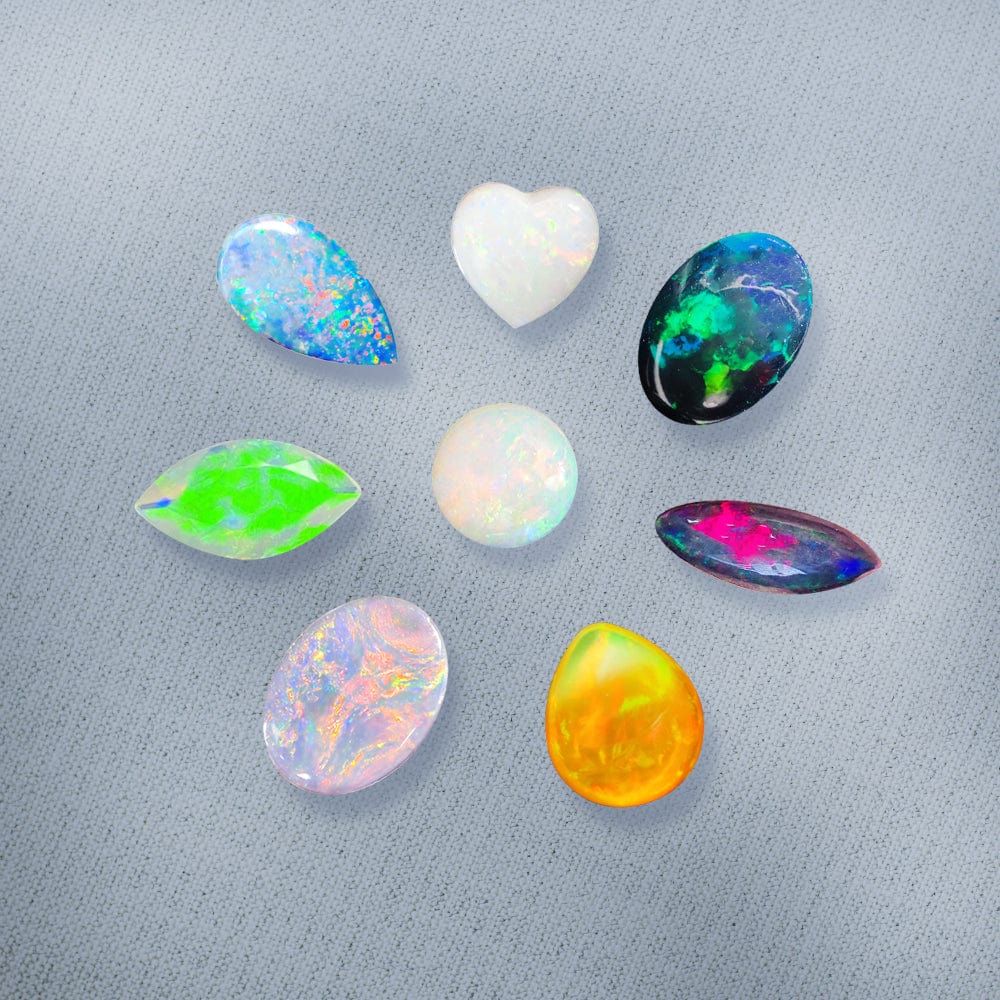 Collection of multicolored opal stones on a gray background
