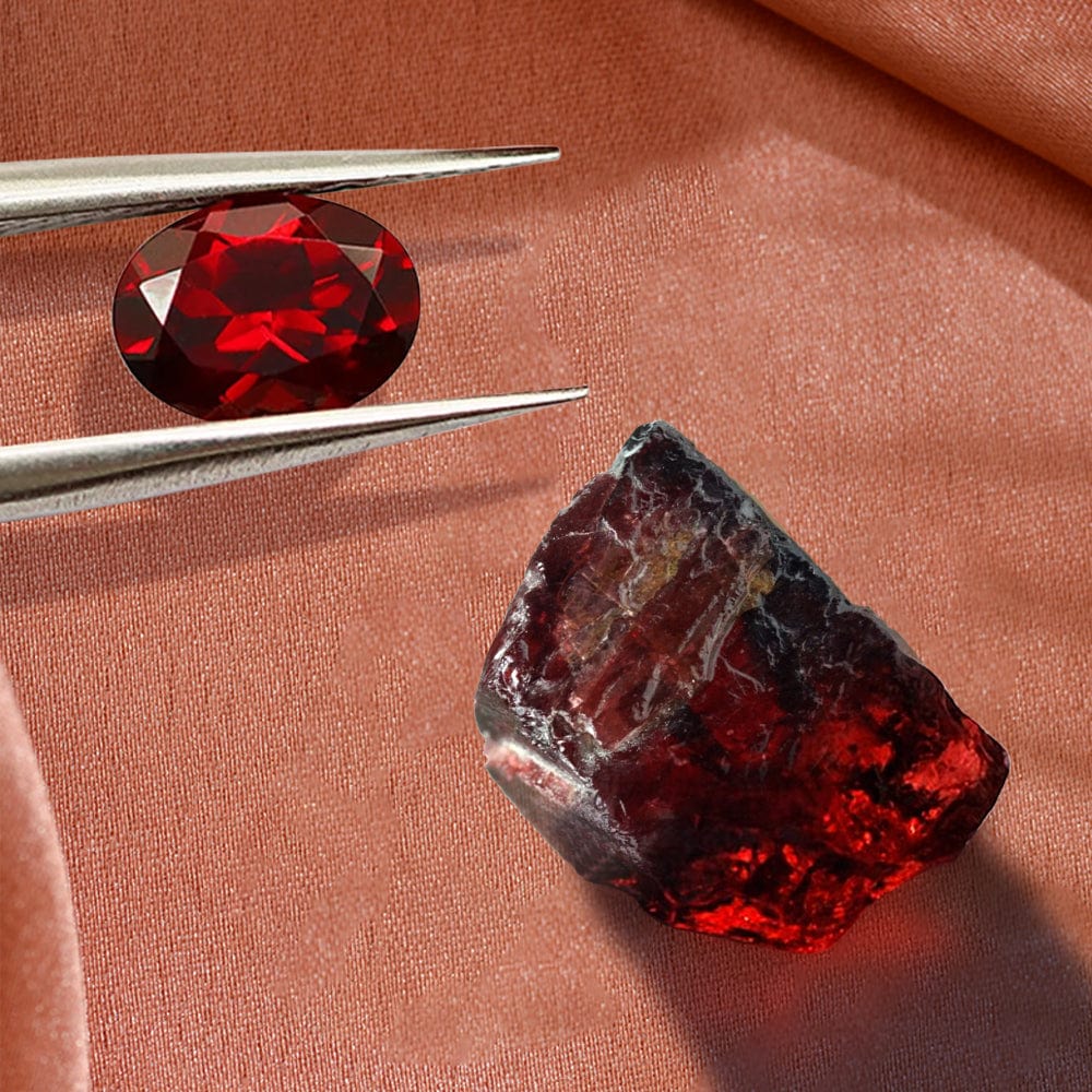 Garnet gemstone and its rough counterpart on a brown fabric background