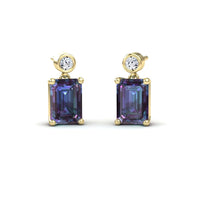 The Lab Grown Alexandrite & White Diamond Drop Earrings - Gracia feature round white diamonds above large emerald-cut alexandrite gemstones, all prong-set and shown on a white background.