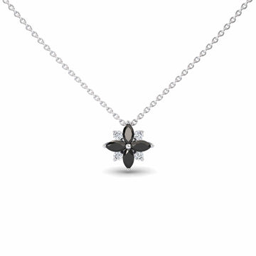 The Black & White Diamond Flower Necklace - Keira is a silver chain necklace with a flower-shaped pendant featuring four black marquise stones as petals and small clear stones between them.