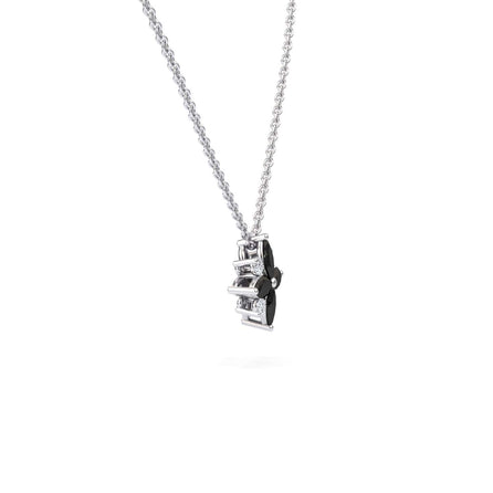 The Keira Black & White Diamond Flower Necklace features a silver chain and a pendant with black and clear geometric shapes, set vertically, shown on a plain white background.