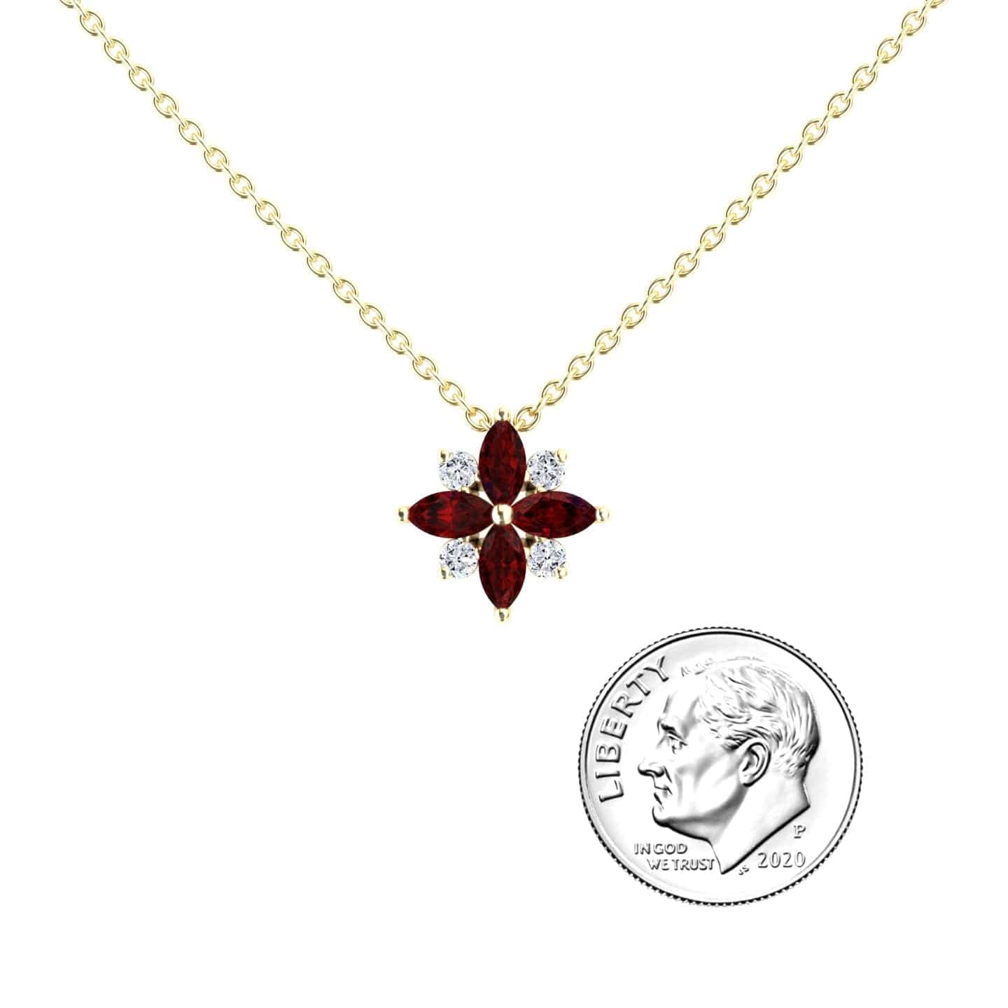 The Ruby & Diamond Flower Necklace - Keira features a gold chain with a flower pendant of four marquise red stones and four small white stones, shown beside a 2020 U.S. dime for size reference.
