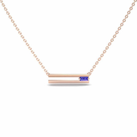 The Tanzanite Bar Necklace - Cecilia features a delicate gold chain with a horizontal bar pendant, accented by a small rectangular blue tanzanite gemstone for a modern, minimalist look.