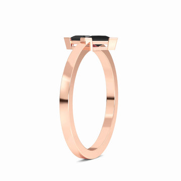 The Black Diamond Triangle Statement Ring - Shalini features a sleek rose gold band with a modern prong setting showcasing a striking triangular black gemstone, displayed on a white background.