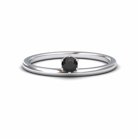 The Black Diamond Solitaire Petite Ring - Faria features a single round black diamond held by six prongs in a simple silver band, shown against a plain white background.