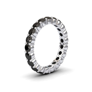 The Black Diamond Prong-Set Eternity Band - Mahira is a silver ring featuring a continuous row of round black diamonds in prong settings, shown against a white background.