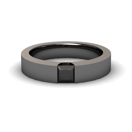 The Black Diamond Solitaire Mens Band - Xiuling features a sleek, modern design with a flat, polished black band and a square black gemstone set flush at the center.