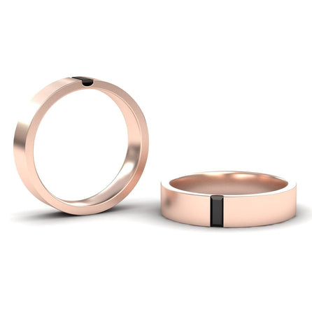 The Hudson Black Diamond 4.5mm Mens Band features a modern rose gold design with a single rectangular black inlay; one ring stands upright and the other lies flat, highlighting the sleek inlay detail.