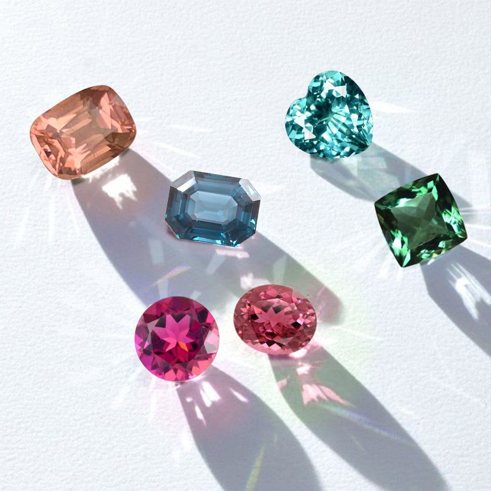 Collection of colorful tourmaline gemstones on a white background
