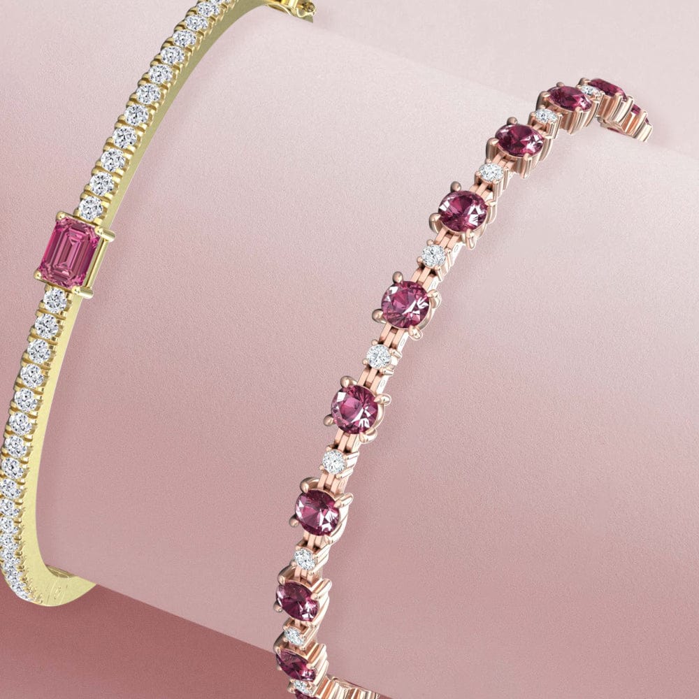Gold bracelet with tourmaline gemstones on a pink background