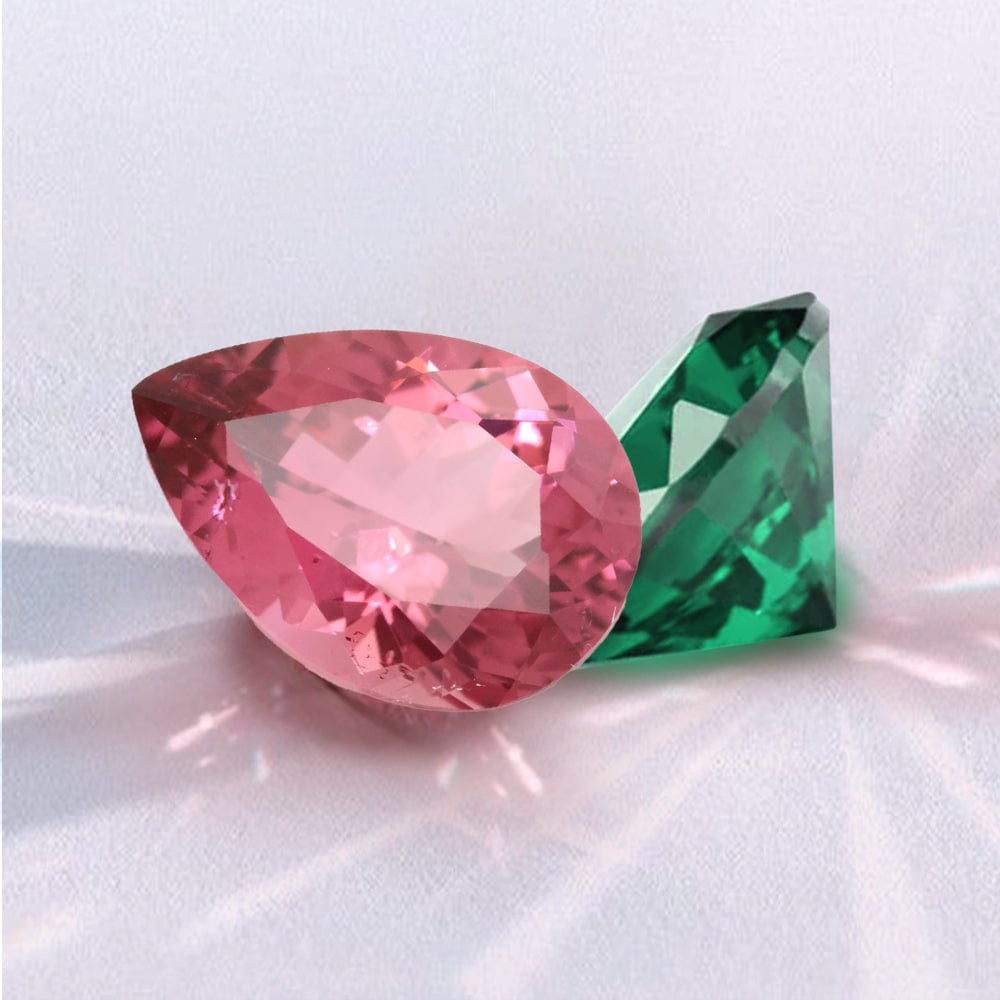 Pink and green tourmaline gemstones on a white background