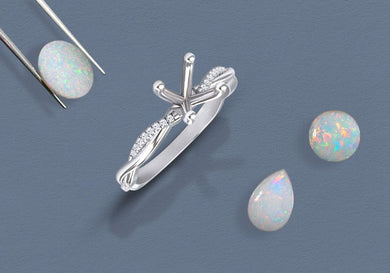 Silver ring with opal stones on a blue background