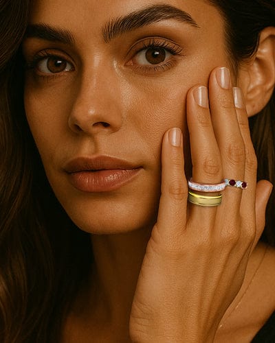 Close-up of a woman's face with jewelry on her hand