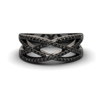The Black Diamond Criss-Cross Pave Band Ring - Eden features multiple thin black bands set with sparkling black stones in a bold, modern design. Shown on a white background, it’s an elegant statement piece.